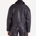 Back view of women's oversized leather biker jacket, showing seam details and relaxed fit