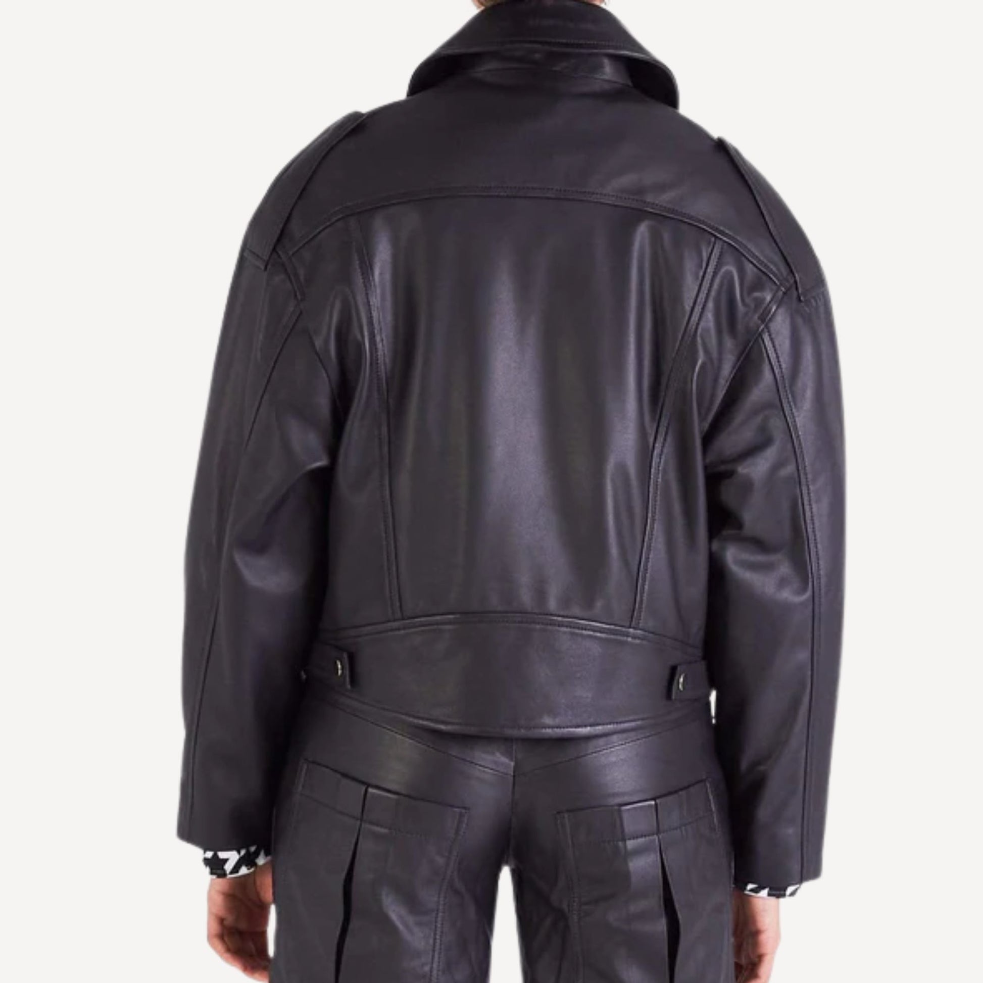 Back view of women's oversized leather biker jacket, showing seam details and relaxed fit