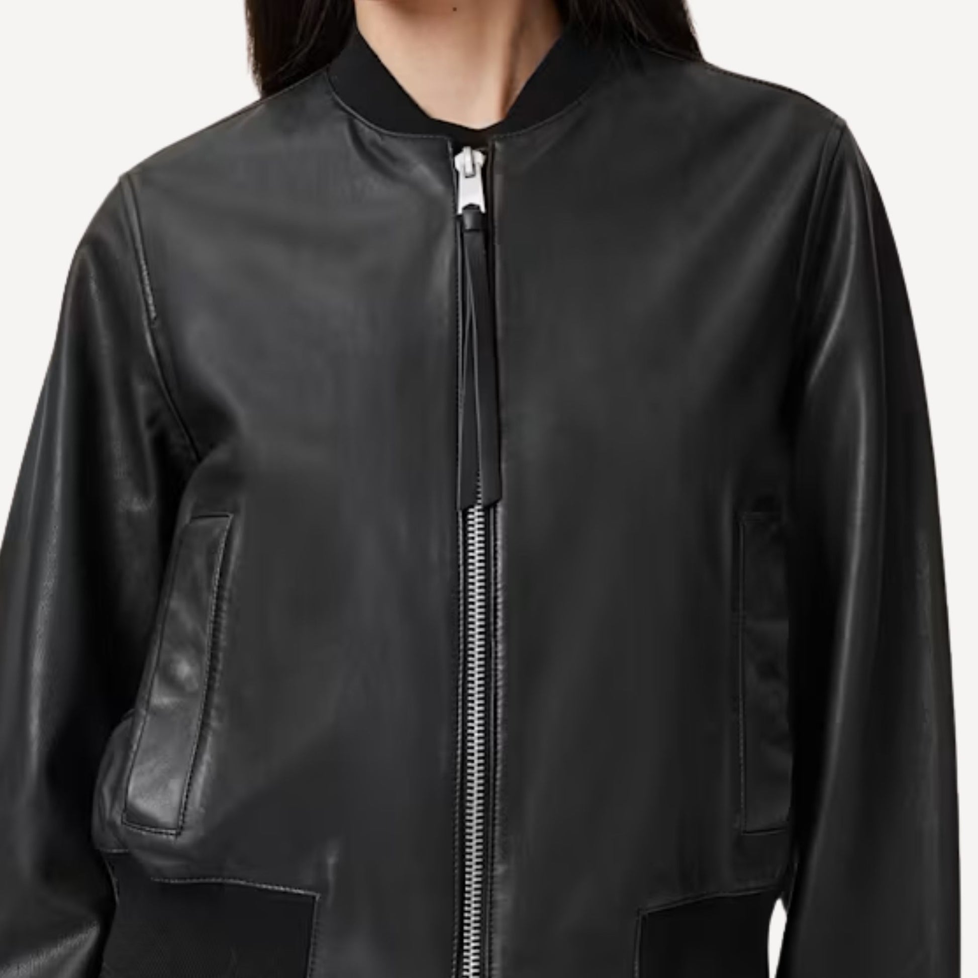 Women’s black bomber leather jacket styled for casual wear.