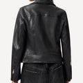 Cropped biker leather jacket with stylish gold accents.