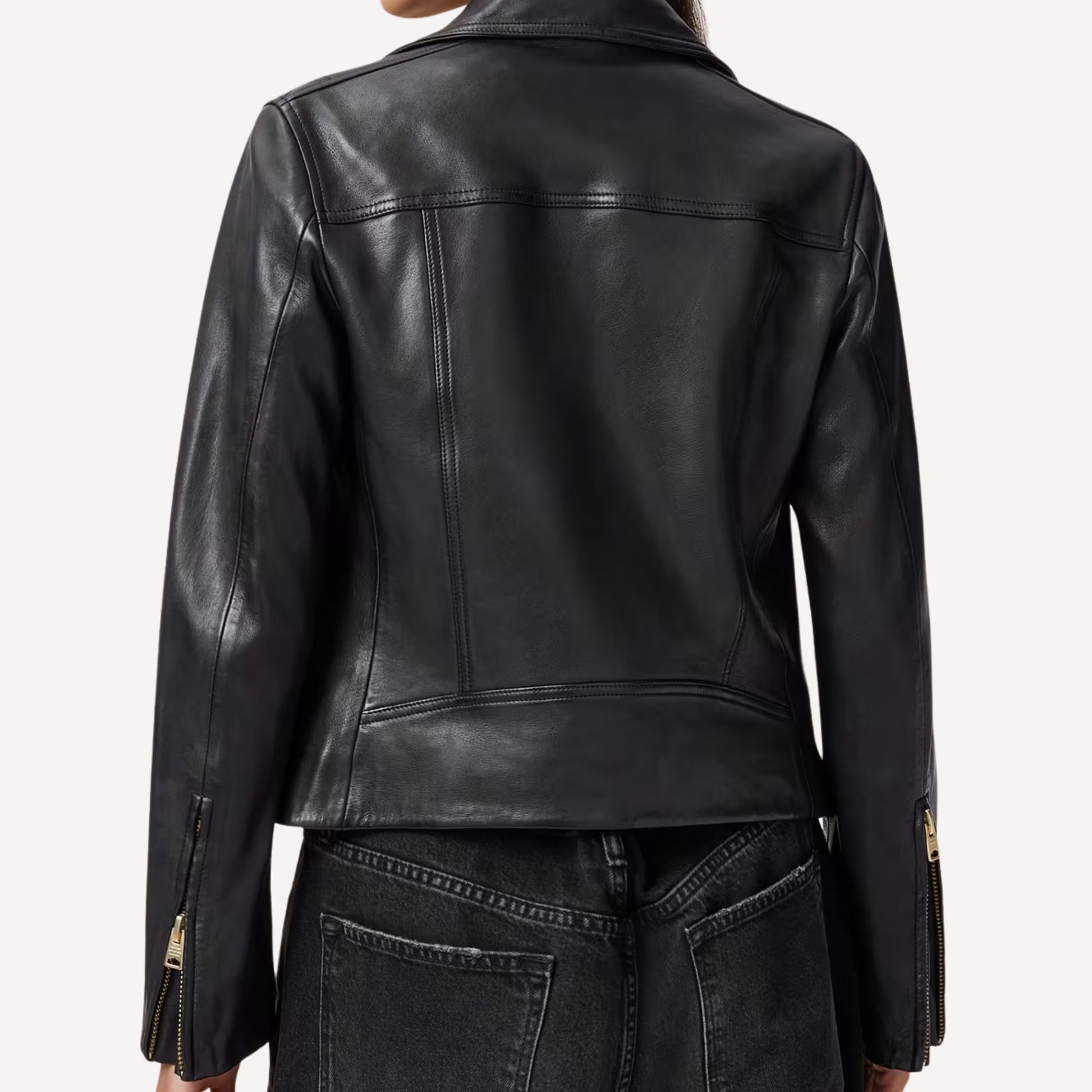 Cropped biker leather jacket with stylish gold accents.