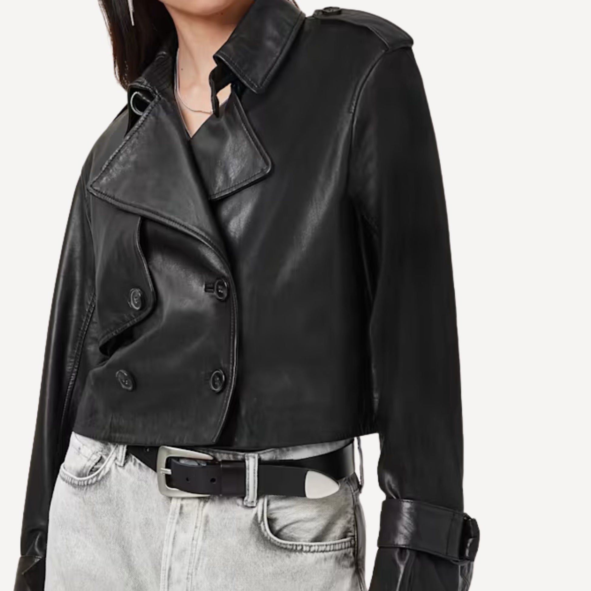 Side profile of women's cropped leather trench coat in sleek black finish