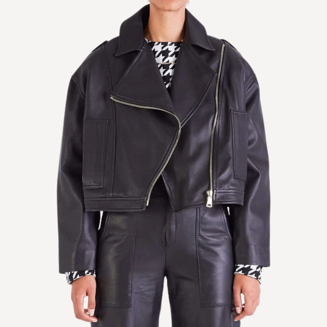 Women's premium oversized black leather biker jacket, front view, styled casually.